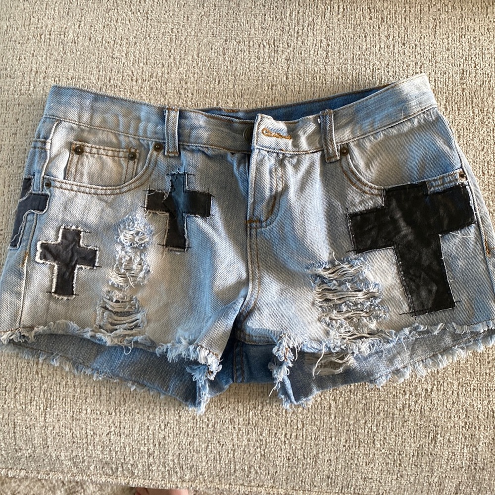 Cut off denim shorts with black crosses